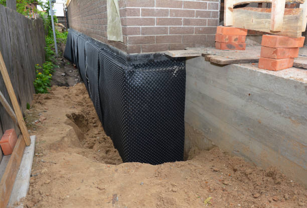 SJ Waterproofing Pros technician performing targeted Interior Drainage System assessment in Theodore, AL